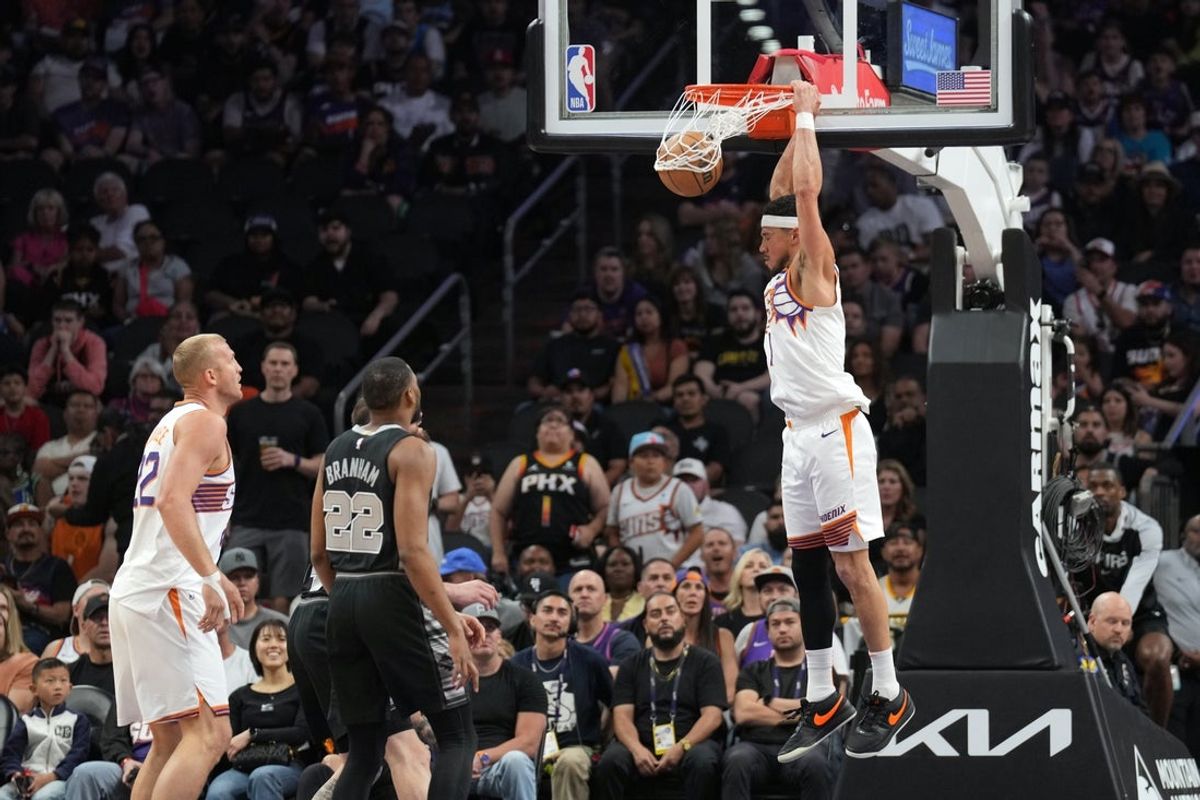 Apr 11, 2025; Phoenix, Arizona, USA; Phoenix Suns guard Devin Booker (1) dunks against the San Antonio Spurs during the first half at Footprint Center. Mandatory Credit: Joe Camporeale-Imagn Images