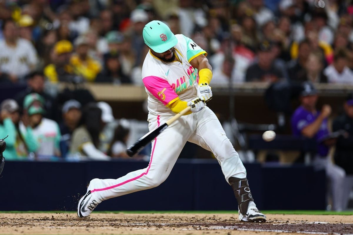 Apr 11, 2025; San Diego, California, USA; San Diego Padres catcher Elias Diaz (17) hits a two RBI single in the fifth inning against the Colorado Rockies at Petco Park. Mandatory Credit: Chadd Cady-Imagn Images