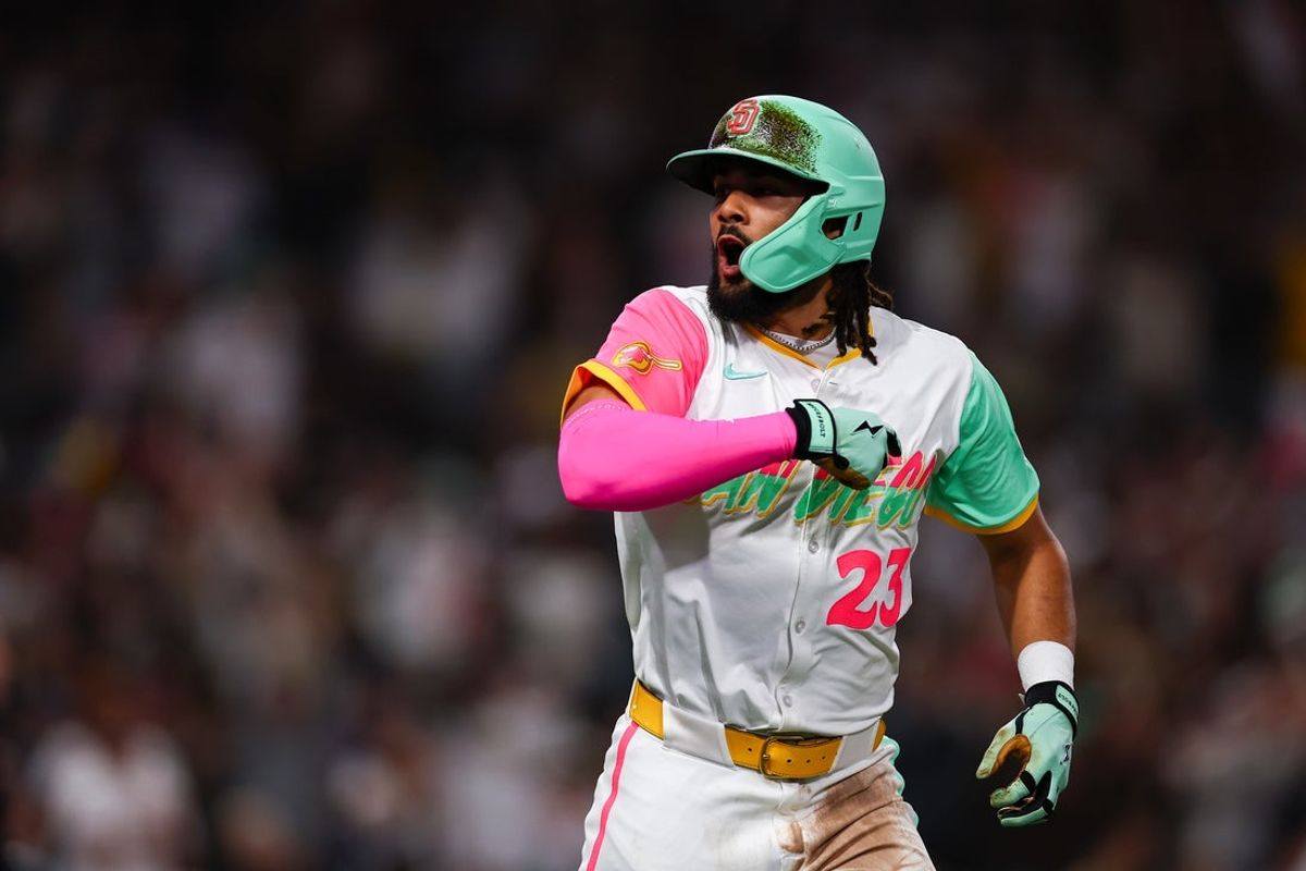 Apr 11, 2025; San Diego, California, USA; San Diego Padres right fielder Fernando Tatis Jr. (23) hits a solo home run in the sixth inning against the Colorado Rockies at Petco Park. Mandatory Credit: Chadd Cady-Imagn Images