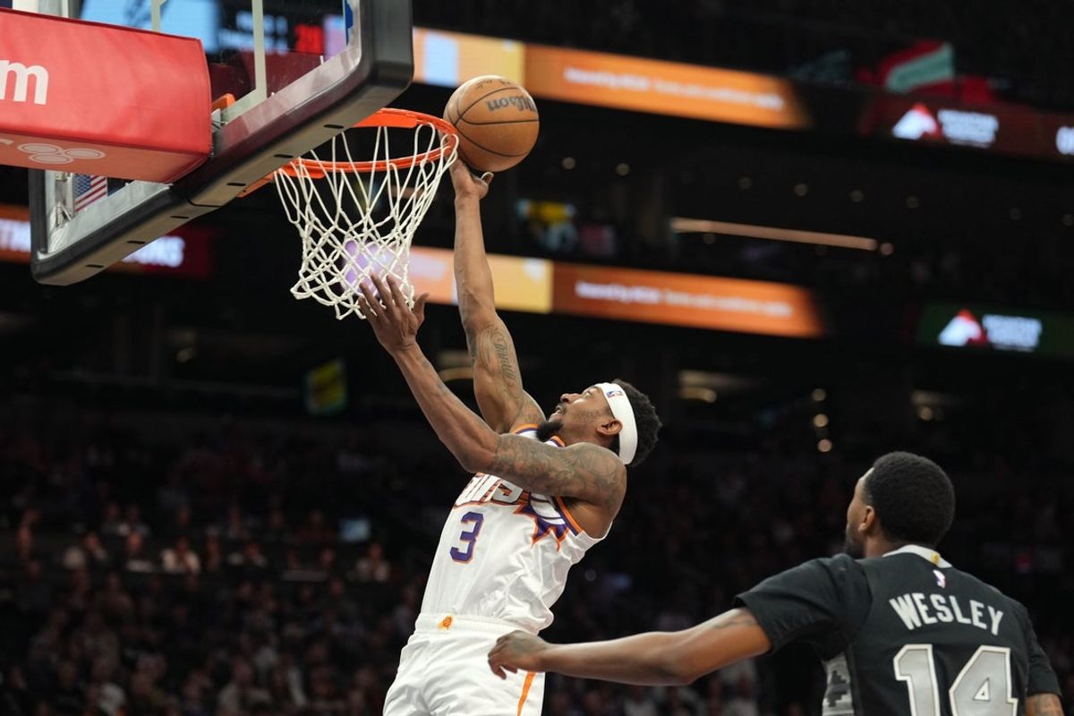 Apr 11, 2025; Phoenix, Arizona, USA; Phoenix Suns guard Bradley Beal (3) puts up a layup against San Antonio Spurs guard Blake Wesley (14) during the second half at Footprint Center. Mandatory Credit: Joe Camporeale-Imagn Images