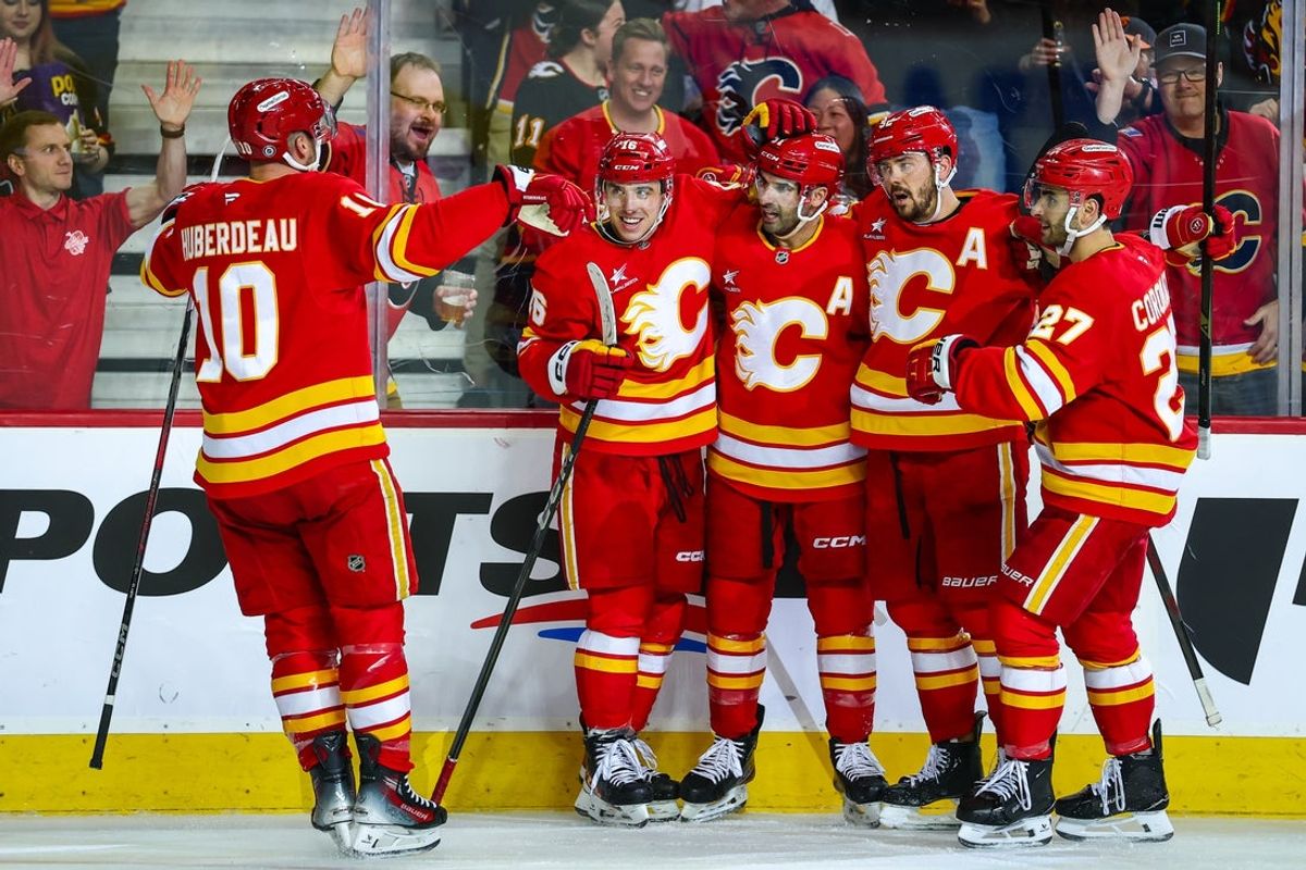 Apr 11, 2025; Calgary, Alberta, CAN; Calgary Flames center Nazem Kadri (91) celebrates his goal with teammates against the Minnesota Wild during the second period at Scotiabank Saddledome. Mandatory Credit: Sergei Belski-Imagn Images