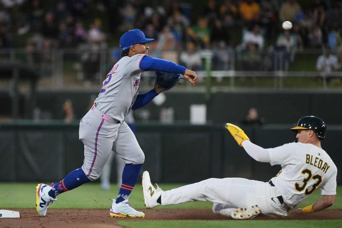 Apr 11, 2025; West Sacramento, California, USA; New York Mets shortstop Francisco Lindor (12) throws to first in an attempt to turn a double play during the first inning of the game against the Oakland Athletics at Sutter Health Park. Mandatory Credit: Ed Szczepanski-Imagn Images