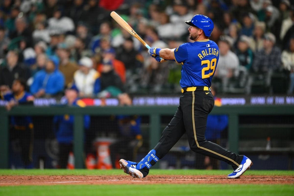 Apr 11, 2025; Seattle, Washington, USA; Seattle Mariners catcher Cal Raleigh (29) hits a 2-run home run with a torpedo bat against the Texas Rangers during the eighth inning at T-Mobile Park. Mandatory Credit: Steven Bisig-Imagn Images