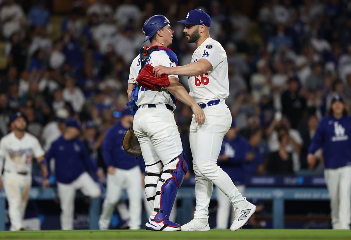 Apr 11, 2025; Los Angeles, California, USA; Los Angeles Dodgers pitcher Tanner Scott (66) and catcher Will Smith (16) celebrate after defeating the Chicago Cubs at Dodger Stadium. Mandatory Credit: Kiyoshi Mio-Imagn Images