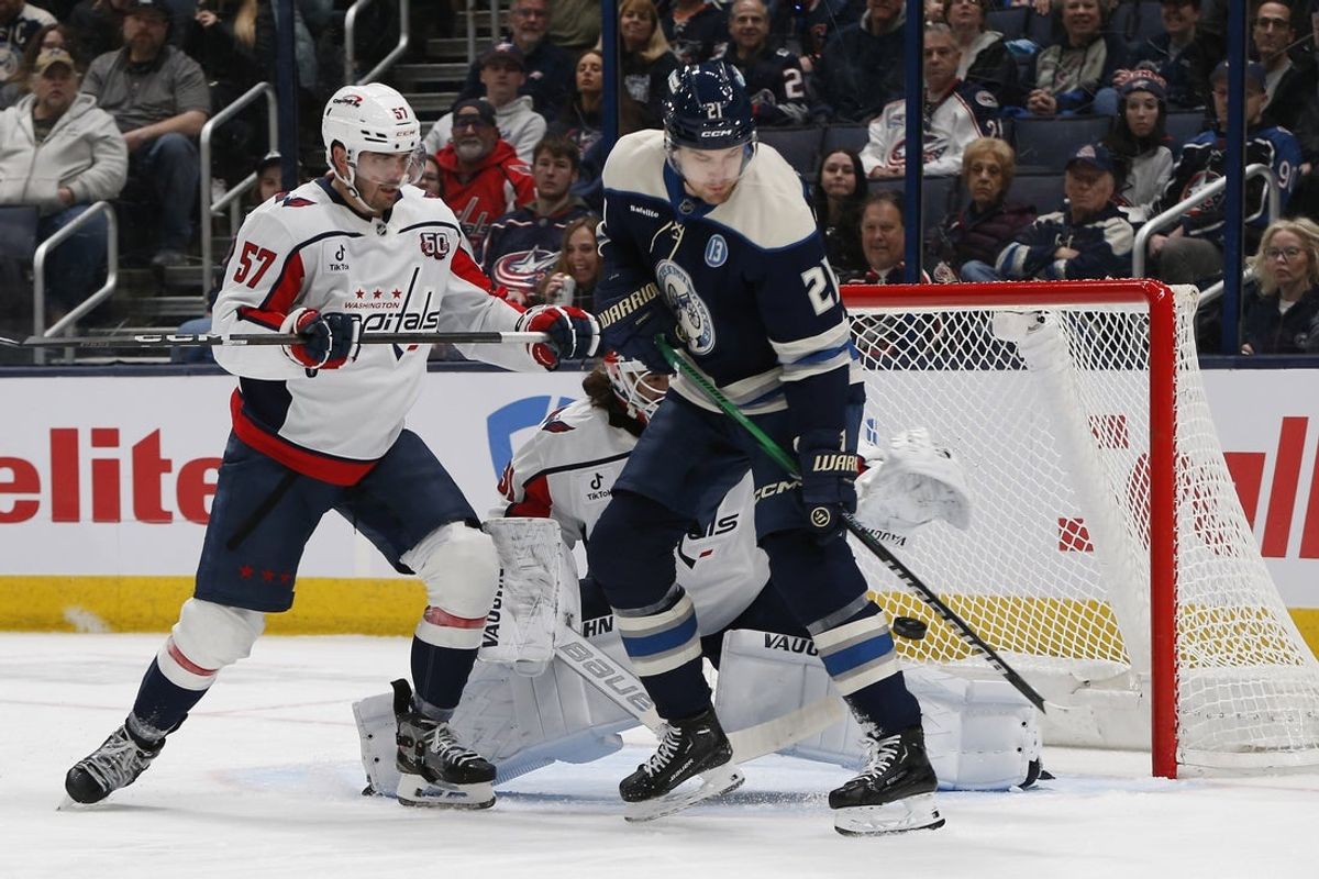 Apr 12, 2025; Columbus, Ohio, USA; Columbus Blue Jackets left wing James van Riemsdyk (21) tips a shot wide as Washington Capitals defenseman Trevor van Riemsdyk (57) defends during the first period at Nationwide Arena. Mandatory Credit: Russell LaBounty-Imagn Images