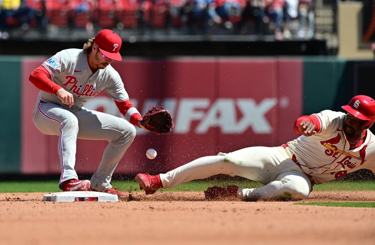 Apr 12, 2025; St. Louis, Missouri, USA; Philadelphia Phillies second base Bryson Stott (5) drops the ball as St. Louis Cardinals outfielder Jordan Walker (18) slides safely into second base after hitting a double in the fifth inning at Busch Stadium. Mandatory Credit: Tim Vizer-Imagn Images