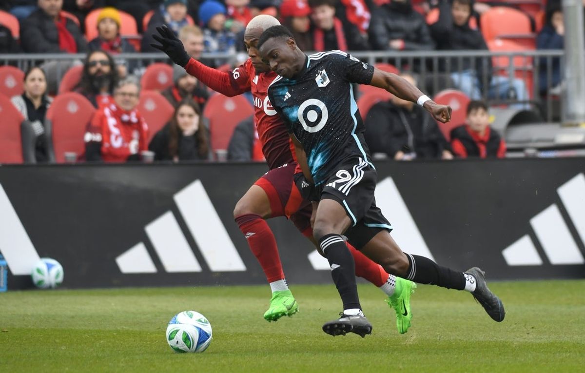 Apr 12, 2025; Toronto, Ontario, CAN;  Minnesota United forward Kelvin Yeboah (9) pursues the ball against Toronto FC midfielder Deybi Flores (20) in the second half at BMO Field. Mandatory Credit: Dan Hamilton-Imagn Images