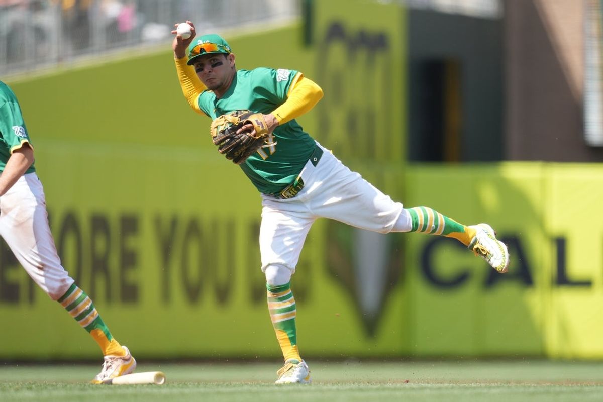 Apr 12, 2025; West Sacramento, California, USA; Athletics third baseman Luis Urias (17) throws the ball to first to record an out against the New York Mets in the fifth inning at Sutter Health Park. Mandatory Credit: Cary Edmondson-Imagn Images