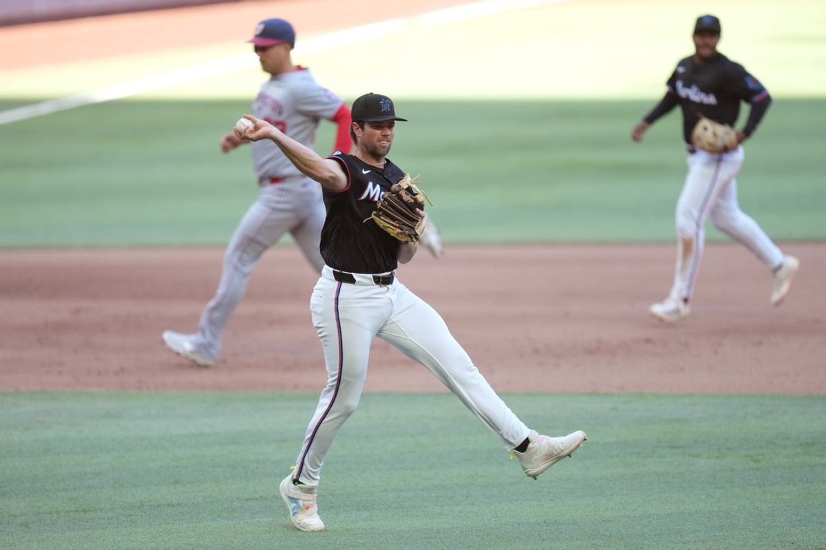 Apr 12, 2025; Miami, Florida, USA;  Miami Marlins third baseman Graham Pauley (21) makes an off-balanced throw  to first base for an out against the Washington Nationals in the fourth inning at loanDepot Park. Mandatory Credit: Jim Rassol-Imagn Images