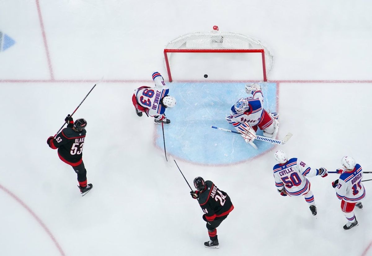Apr 12, 2025; Raleigh, North Carolina, USA;  Carolina Hurricanes right wing Jackson Blake (53) scores a goal past New York Rangers goaltender Igor Shesterkin (31) and  center Mika Zibanejad (93) during the second period at Lenovo Center. Mandatory Credit: James Guillory-Imagn Images