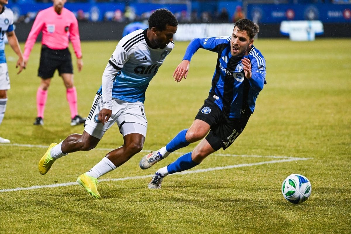 Apr 12, 2025; Montreal, Province of Quebec, CAN; Charlotte FC defender Nathan Byrne (14) defends teh ball against CF Montreal defender Luca Petrasso (13) during the first half at Saputo Stadium. Mandatory Credit: David Kirouac-Imagn Images
