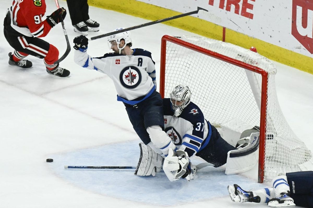 Apr 12, 2025; Chicago, Illinois, USA;  Winnipeg Jets defenseman Josh Morrissey (44) and goaltender Connor Hellebuyck (37) defend against the Chicago Blackhawks during the second period at United Center. Mandatory Credit: Matt Marton-Imagn Images
