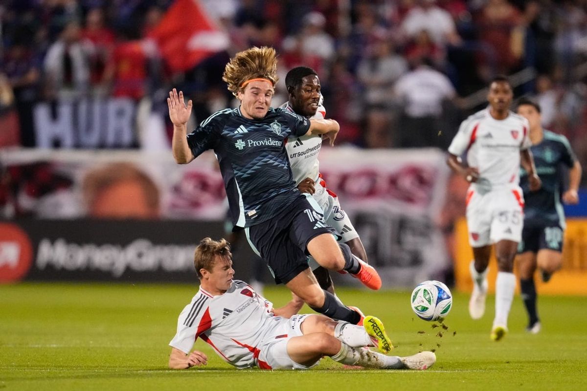Apr 12, 2025; Frisco, Texas, USA;  FC Dallas defender Nolan Norris (32) draws a yellow card for a foul against Seattle Sounders forward Pedro De La Vega (10) during the first half at Toyota Stadium. Mandatory Credit: Chris Jones-Imagn Images