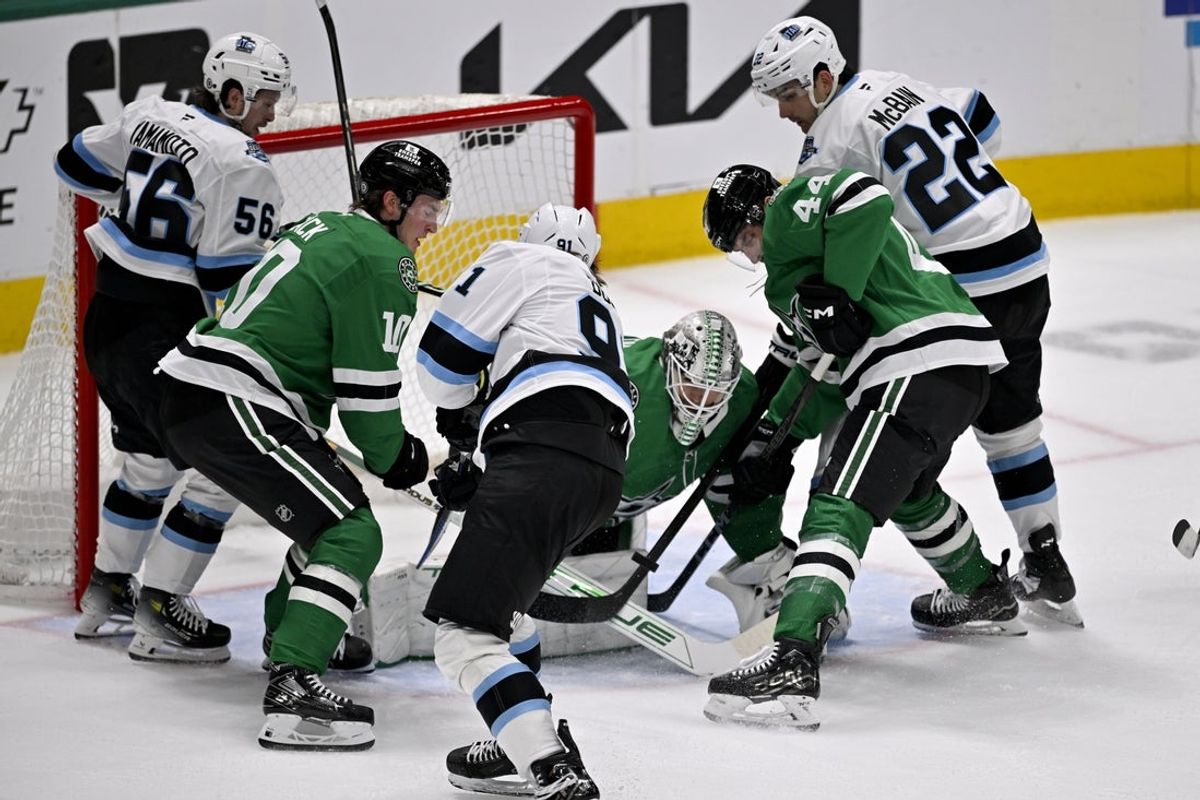 Apr 12, 2025; Dallas, Texas, USA; Utah Hockey Club right wing Josh Doan (91) scores a goal against Dallas Stars goaltender Casey DeSmith (1) during the second period at the American Airlines Center. Mandatory Credit: Jerome Miron-Imagn Images