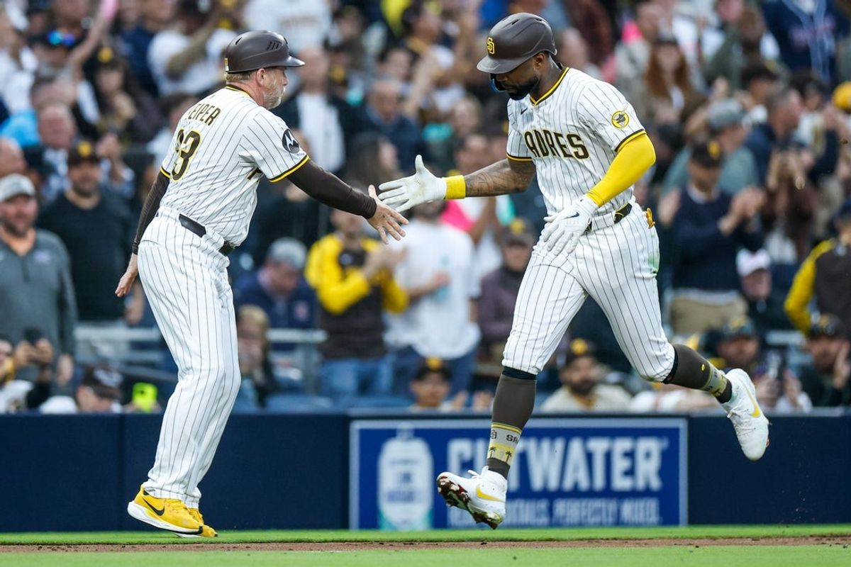 Apr 12, 2025; San Diego, California, USA; San Diego Padres left fielder Jason Heyward (22) celebrates with San Diego Padres third base coach Tim Leiper (33) after hitting a one-run home run during the fifth inning against the Colorado Rockies at Petco Park. Mandatory Credit: David Frerker-Imagn Images