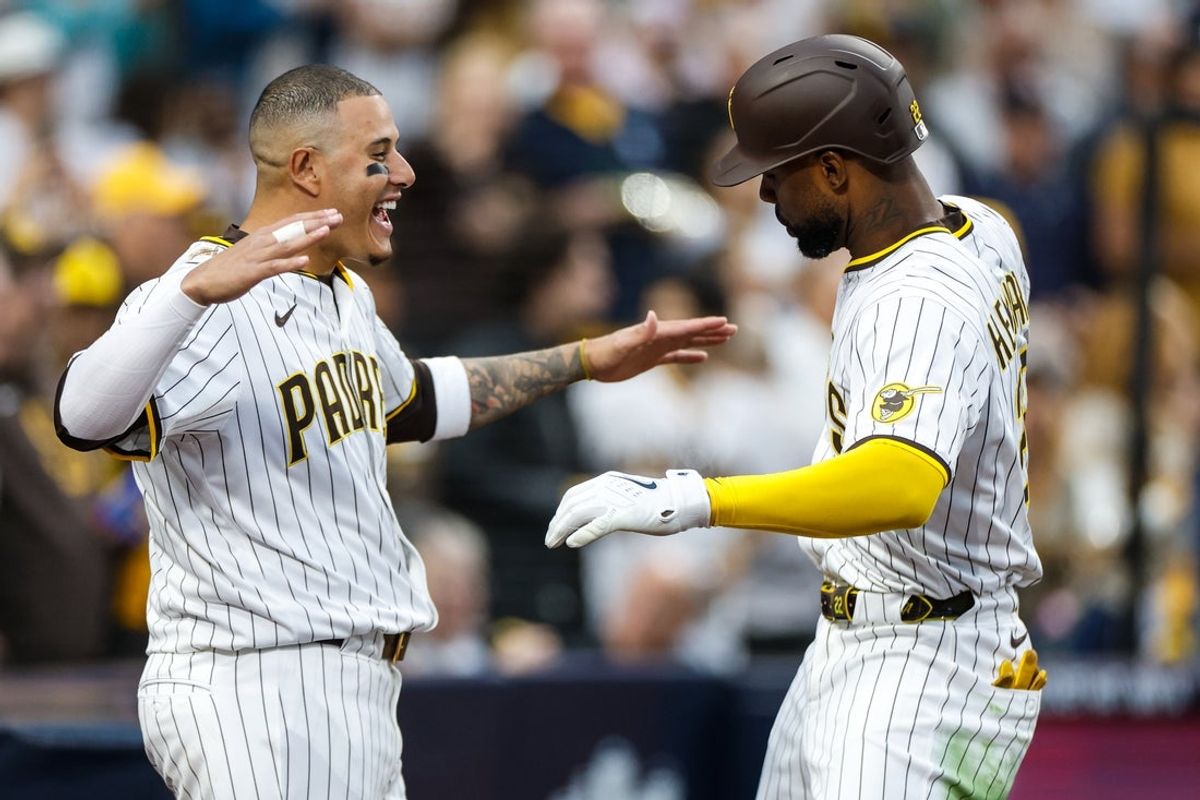 Apr 12, 2025; San Diego, California, USA; San Diego Padres left fielder Jason Heyward (22) celebrates with San Diego Padres third baseman Manny Machado (13) after hitting a one-run home run during the fifth inning against the Colorado Rockies at Petco Park. Mandatory Credit: David Frerker-Imagn Images
