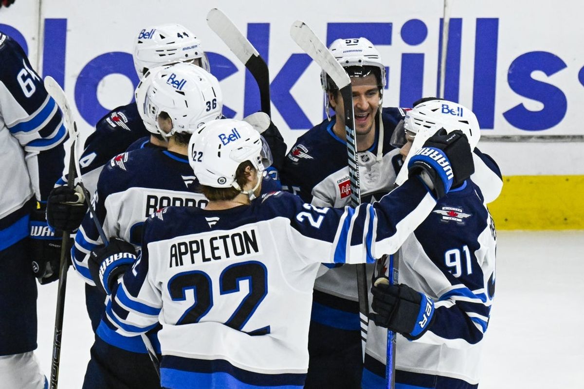 Apr 12, 2025; Chicago, Illinois, USA;  Winnipeg Jets center Cole Perfetti (91) celebrates with teammates after he scores the game winning shootout goal against the Chicago Blackhawks during the overtime period at United Center. Mandatory Credit: Matt Marton-Imagn Images