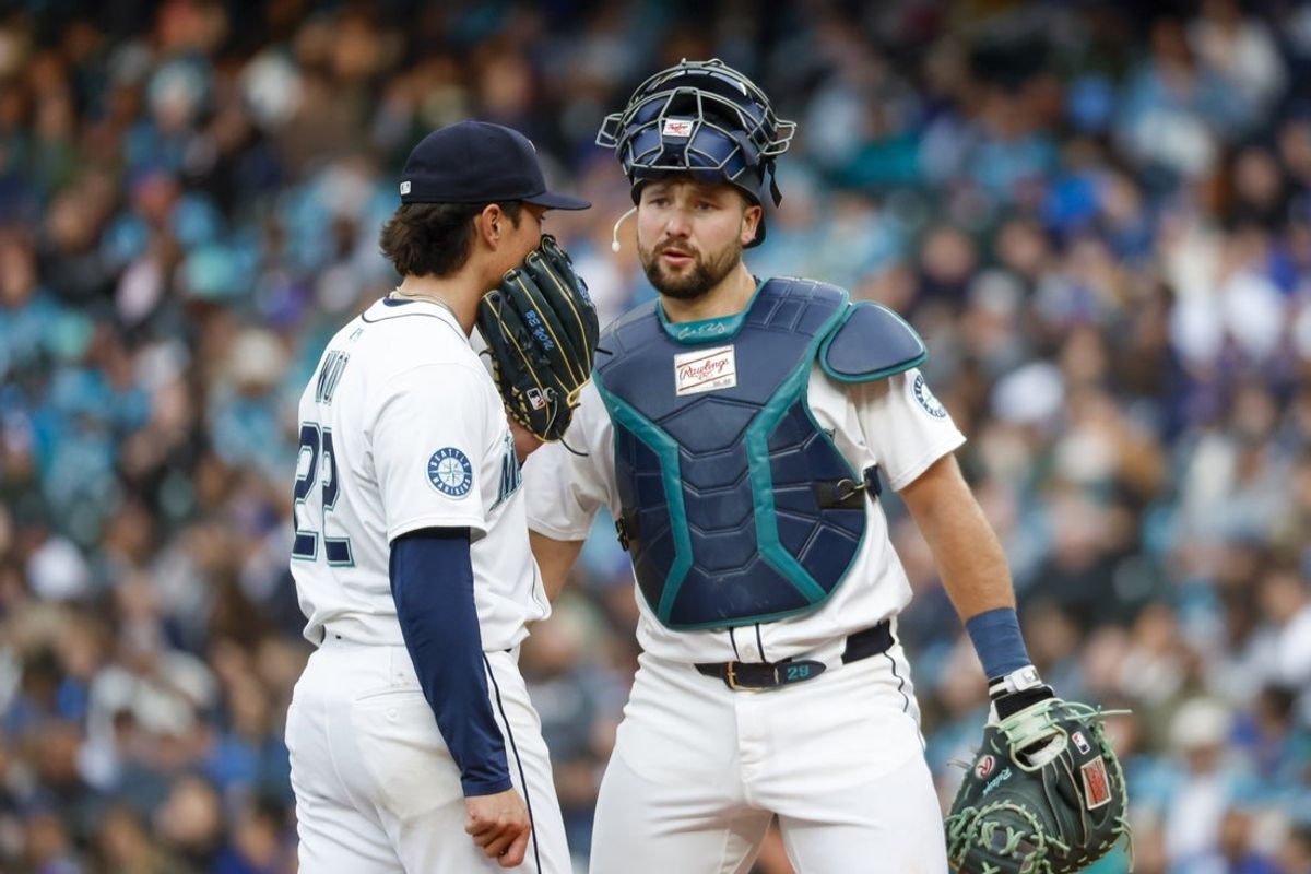 Apr 12, 2025; Seattle, Washington, USA; Seattle Mariners catcher Cal Raleigh (29) talks with starting pitcher Bryan Woo (22) during the first inning against the Texas Rangers at T-Mobile Park. Mandatory Credit: Joe Nicholson-Imagn Images