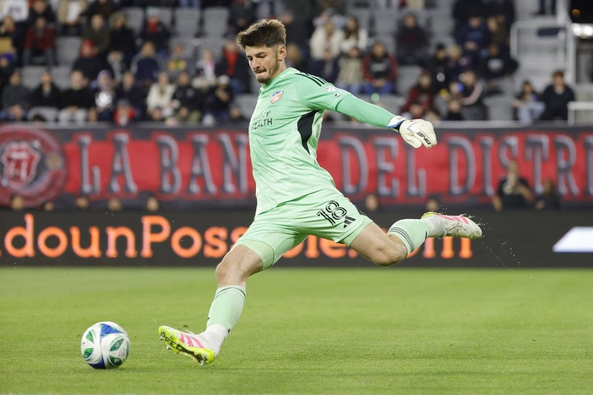 Apr 12, 2025; Washington, District of Columbia, USA; FC Cincinnati goalkeeper Roman Celentano (18) takes a goal kick against D.C. United during the first half at Audi Field. Mandatory Credit: Amber Searls-Imagn Images