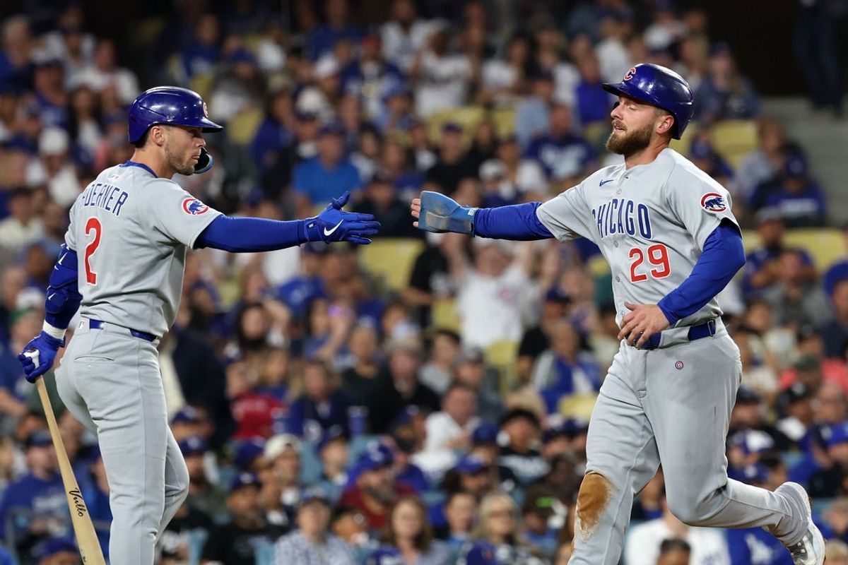 Apr 12, 2025; Los Angeles, California, USA; Chicago Cubs first base Michael Busch (29) reacts after scoring a run with  second base Nico Hoerner (2) during the sixth inning at Dodger Stadium. Mandatory Credit: Kiyoshi Mio-Imagn Images