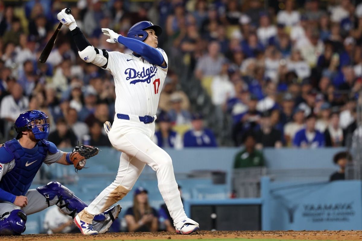 Apr 12, 2025; Los Angeles, California, USA; Los Angeles Dodgers designated hitter Shohei Ohtani (17) flys out against the Chicago Cubs during the seventh inning at Dodger Stadium. Mandatory Credit: Kiyoshi Mio-Imagn Images