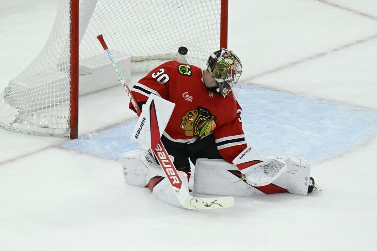 Apr 12, 2025; Chicago, Illinois, USA;  The puck hit by Winnipeg Jets left wing Kyle Connor (81) flies past Chicago Blackhawks goaltender Spencer Knight (30) during the second period at United Center. Mandatory Credit: Matt Marton-Imagn Images