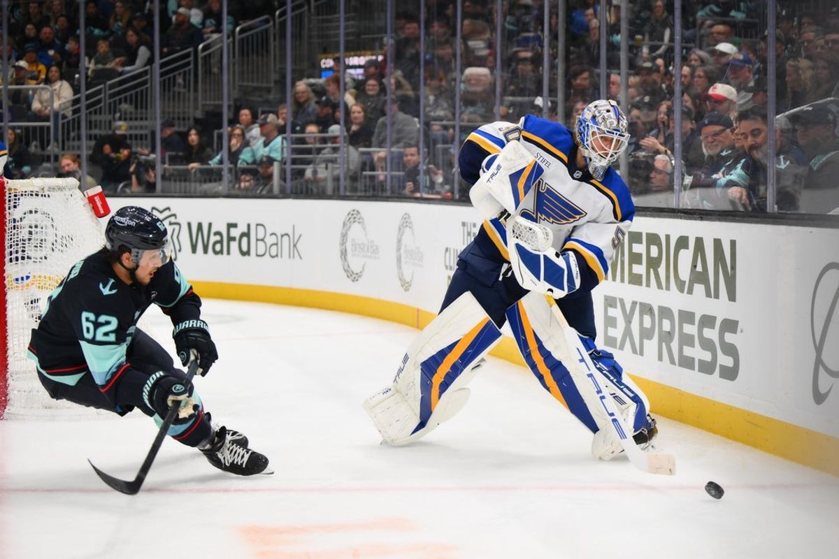 Apr 12, 2025; Seattle, Washington, USA; St. Louis Blues goaltender Jordan Binnington (50) passes the puck against the Seattle Kraken during the second period at Climate Pledge Arena. Mandatory Credit: Steven Bisig-Imagn Images