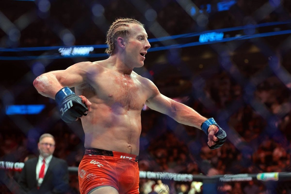 Apr 12, 2025; Miami, Florida, UNITED STATES;  Paddy Pimblett (blue gloves) reacts after defeating Michael Chandler (not pictured) during UFC 314 at Kaseya Center. Mandatory Credit: Sam Navarro-Imagn Images