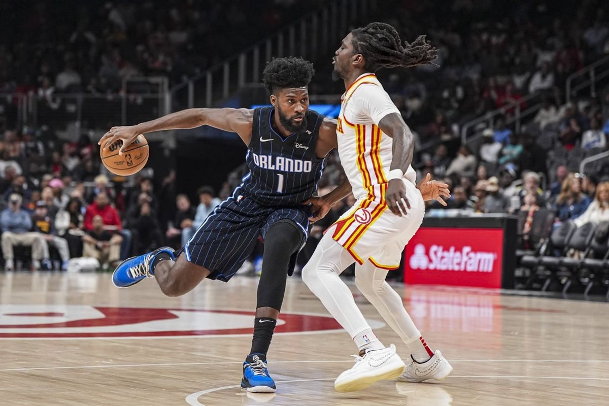 Apr 13, 2025; Atlanta, Georgia, USA; Orlando Magic forward Jonathan Isaac (1) dribbles against Atlanta Hawks guard Keaton Wallace (2) during the first half at State Farm Arena. Mandatory Credit: Dale Zanine-Imagn Images