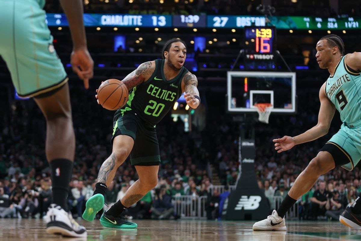 Apr 13, 2025; Boston, Massachusetts, USA; Boston Celtics guard JD Davison (20) dribbles down the court during the first half against the Charlotte Hornets at TD Garden. Mandatory Credit: Paul Rutherford-Imagn Images