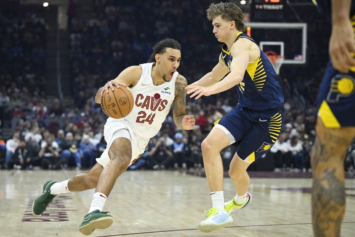 Apr 13, 2025; Cleveland, Ohio, USA; Cleveland Cavaliers forward Jaylon Tyson (24) dribbles beside Indiana Pacers forward Johnny Furphy (12) in the first quarter at Rocket Arena. Mandatory Credit: David Richard-Imagn Images
