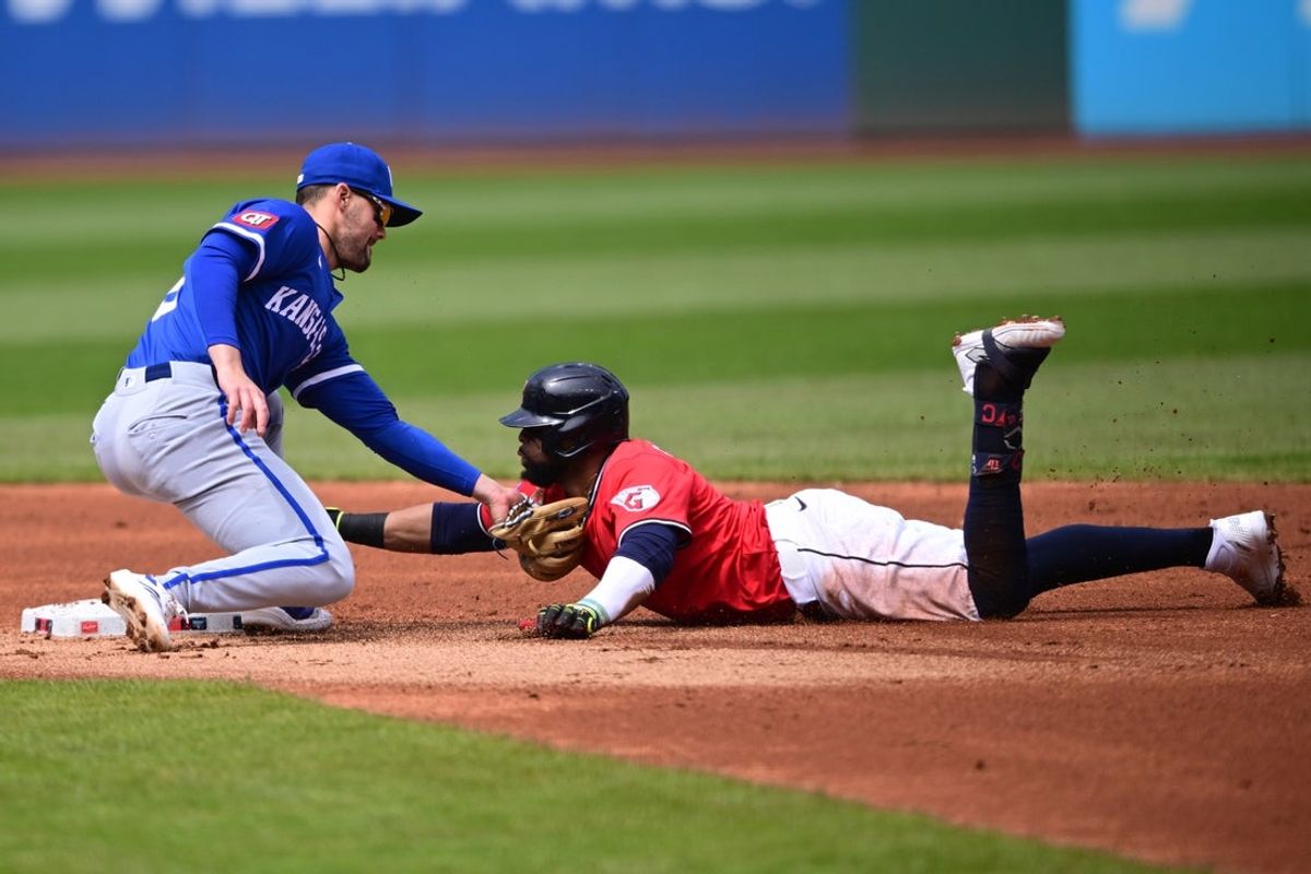 Apr 13, 2025; Cleveland, Ohio, USA; Kansas City Royals second baseman Michael Massey (19) tags out Cleveland Guardians first baseman Carlos Santana (41) at second base during the first inning  at Progressive Field. Mandatory Credit: David Dermer-Imagn Images
