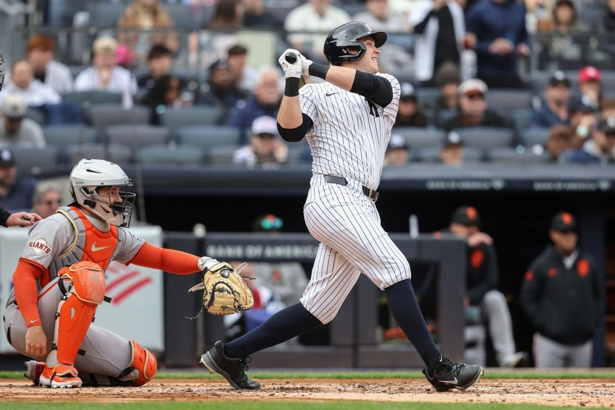Apr 13, 2025; Bronx, New York, USA;  New York Yankees designated hitter Ben Rice (22) hits an RBI single in the second inning against the San Francisco Giants at Yankee Stadium. Mandatory Credit: Wendell Cruz-Imagn Images