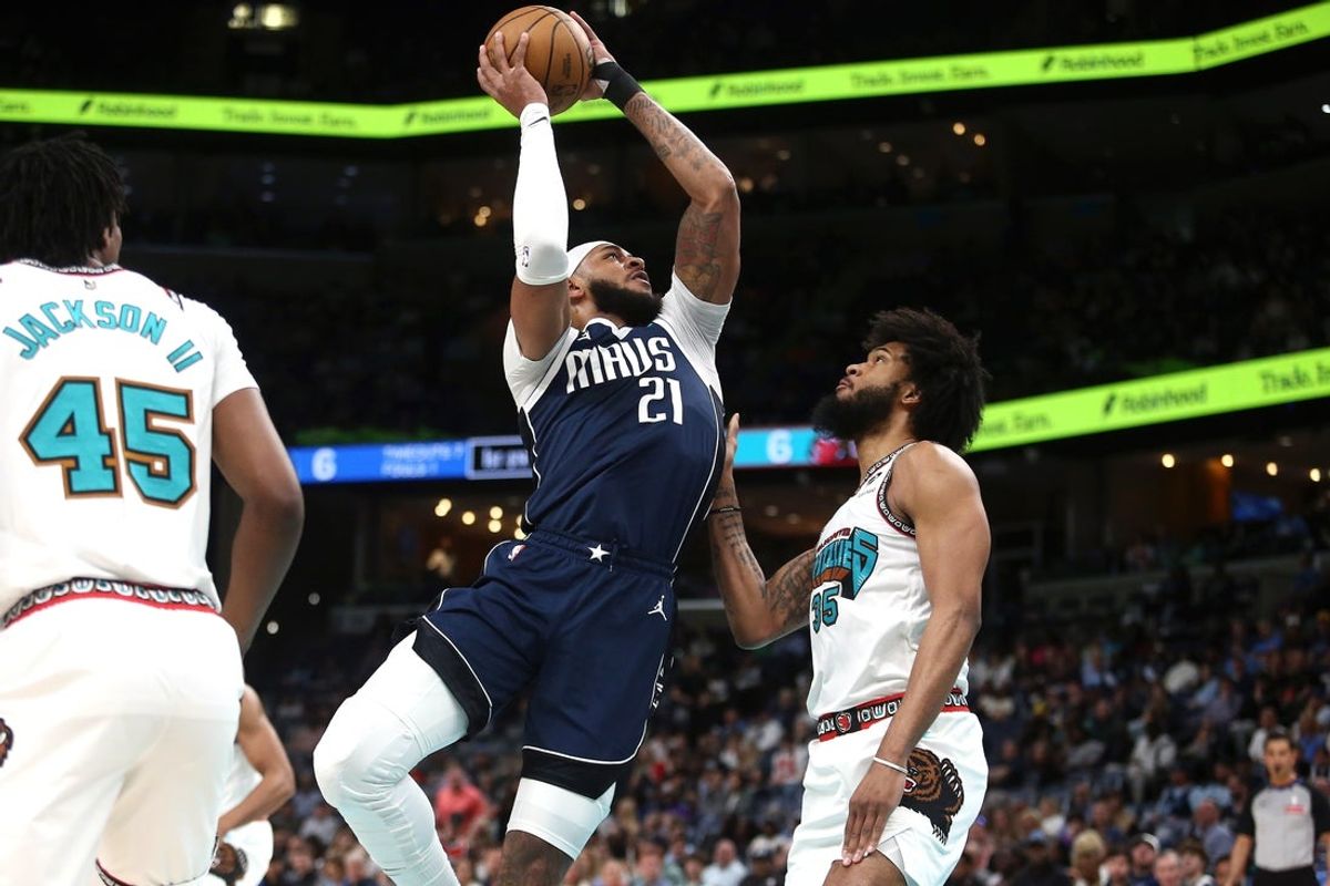 Apr 13, 2025; Memphis, Tennessee, USA; Dallas Mavericks center Daniel Gafford (21) drives to the basket as Memphis Grizzlies forward Marvin Bagley III (35) defends during the first quarter at FedExForum. Mandatory Credit: Petre Thomas-Imagn Images