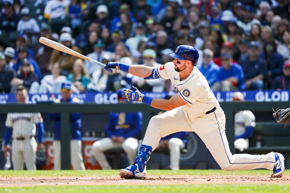 Apr 13, 2025; Seattle, Washington, USA; Seattle Mariners catcher Cal Raleigh (29) hits a two-run home run against the Texas Rangers during the first inning at T-Mobile Park. Mandatory Credit: Joe Nicholson-Imagn Images