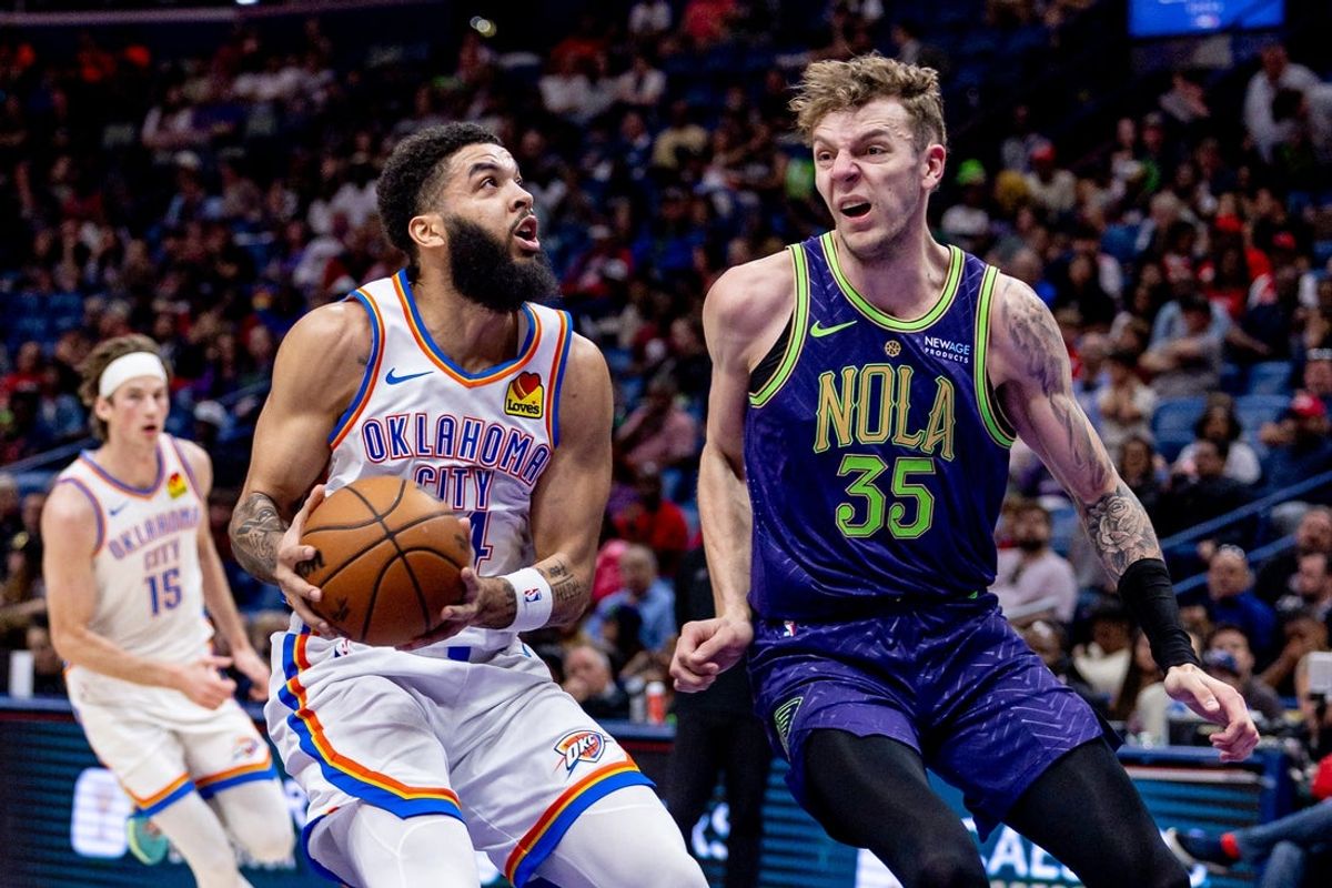 Apr 13, 2025; New Orleans, Louisiana, USA;  Oklahoma City Thunder forward Kenrich Williams (34) dribbles against New Orleans Pelicans center Kylor Kelley (35) during the first half at Smoothie King Center. Mandatory Credit: Stephen Lew-Imagn Images