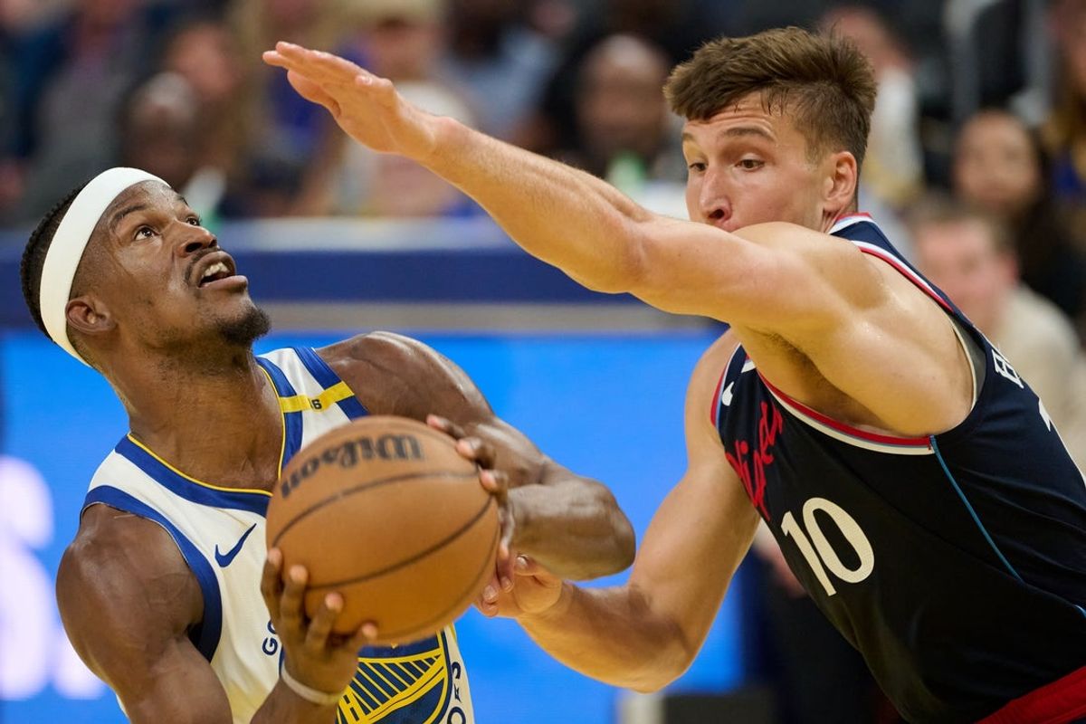 Apr 13, 2025; San Francisco, California, USA; Golden State Warriors forward Jimmy Butler III (10) drives to the basket against LA Clippers guard Bogdan Bogdanovic (10) during the second quarter at Chase Center. Mandatory Credit: Robert Edwards-Imagn Images