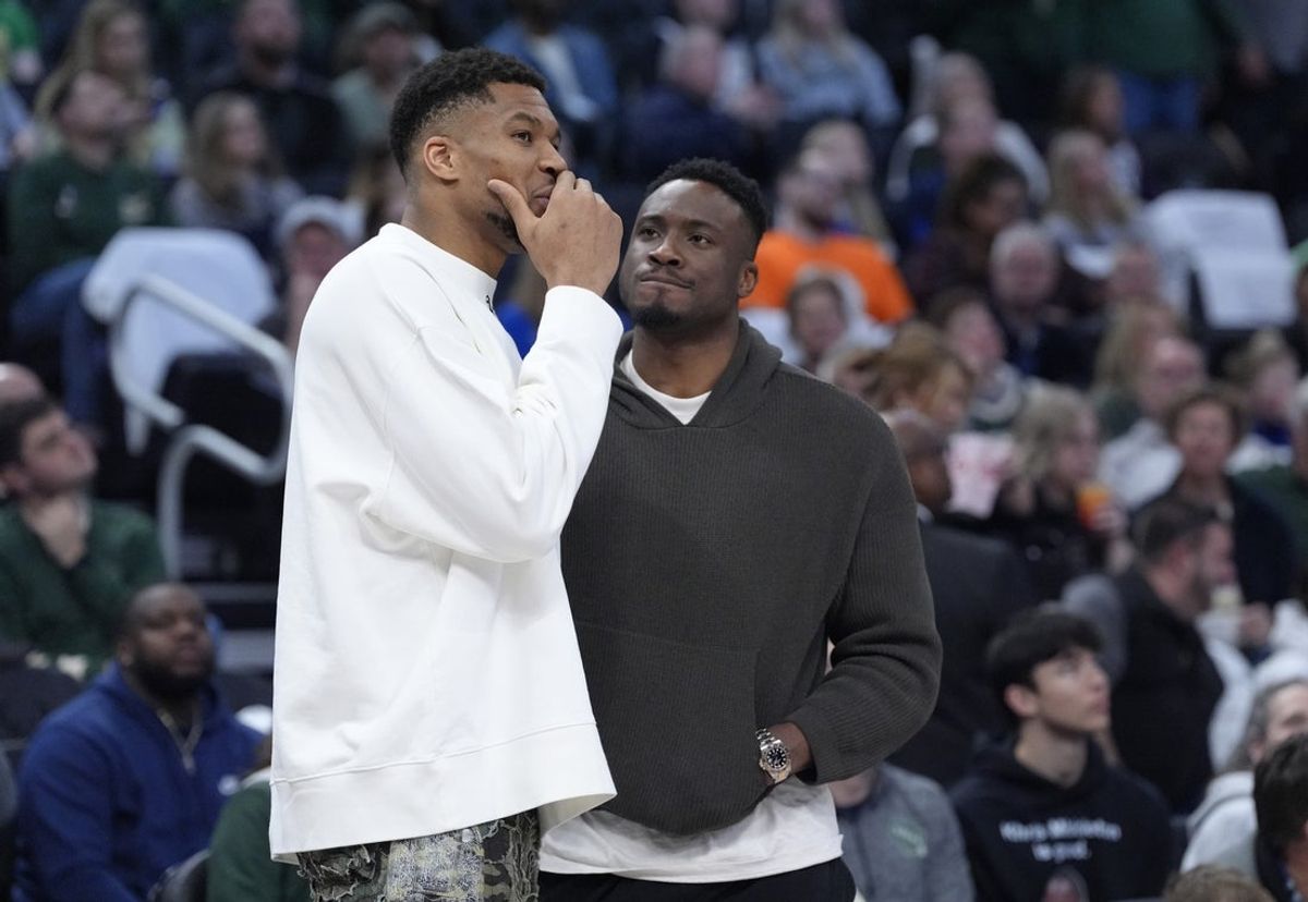 Apr 13, 2025; Milwaukee, Wisconsin, USA;  Milwaukee Bucks forward Giannis Antetokounmpo (34) and his brother Milwaukee Bucks forward Thanasis Antetokounmpo  talks during a time out against the Detroit Pistons in the second half at Fiserv Forum. Mandatory Credit: Michael McLoone-Imagn Images