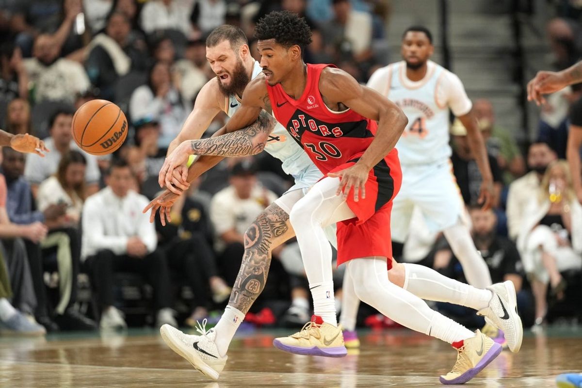 Apr 13, 2025; San Antonio, Texas, USA; Toronto Raptors forward Ochai Agbaji(30) and San Antonio Spurs forward Sandro Mamukelashvili (54) battle for a loose ball during the first half at Frost Bank Center. Mandatory Credit: Scott Wachter-Imagn Images