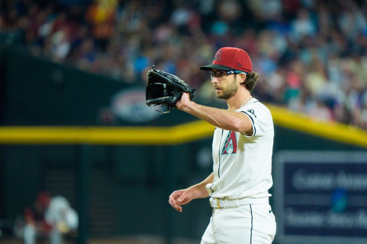 Apr 13, 2025; Phoenix, Arizona, USA;  Arizona Diamondbacks pitcher Zac Gallen (23) calls for the ball while on the mound in the fourth inning against the Milwaukee Brewers at Chase Field. Mandatory Credit: Allan Henry-Imagn Images