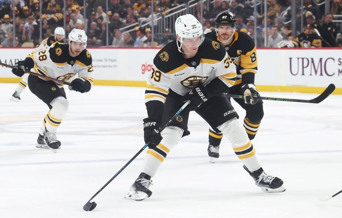 Apr 13, 2025; Pittsburgh, Pennsylvania, USA; Boston Bruins center Morgan Geekie (39) skates with the puck against the Pittsburgh Penguins during the second period at PPG Paints Arena. Mandatory Credit: Charles LeClaire-Imagn Images