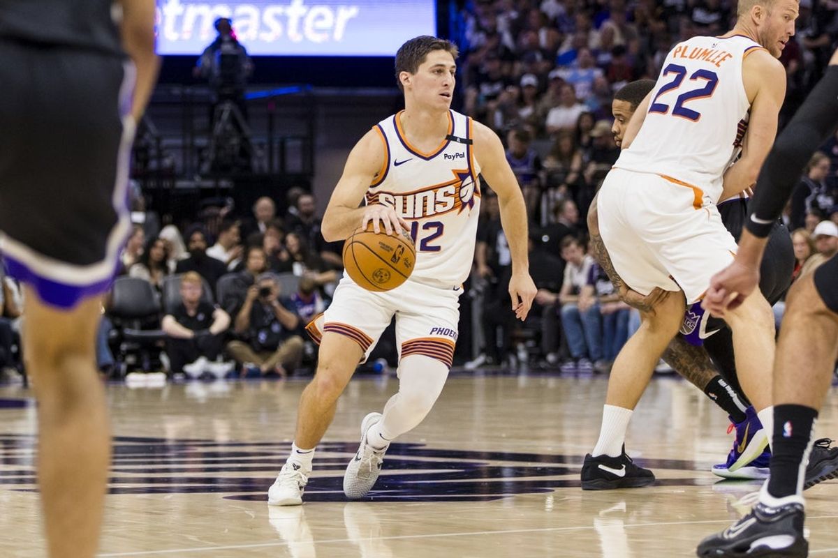 Apr 13, 2025; Sacramento, California, USA;  Phoenix Suns guard Collin Gillespie (12) dribbles against the Sacramento Kings during the fourth quarter at Golden 1 Center. Mandatory Credit: John Hefti-Imagn Images