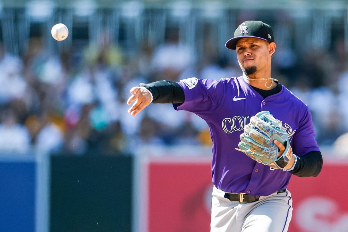 Apr 13, 2025; San Diego, California, USA; Colorado Rockies shortstop Ezequiel Tovar (14) throws to first base to complete the double play during the eighth inning against the San Diego Padres at Petco Park. Mandatory Credit: David Frerker-Imagn Images