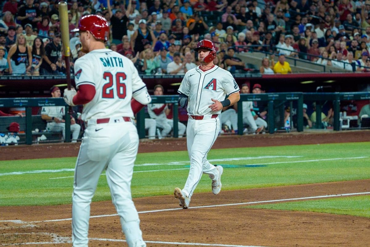 Apr 13, 2025; Phoenix, Arizona, USA;  Arizona Diamondbacks infielder Tim Tawa (13) scores after a wild pitch during the fifth inning against the Milwaukee Brewers at Chase Field. Mandatory Credit: Allan Henry-Imagn Images