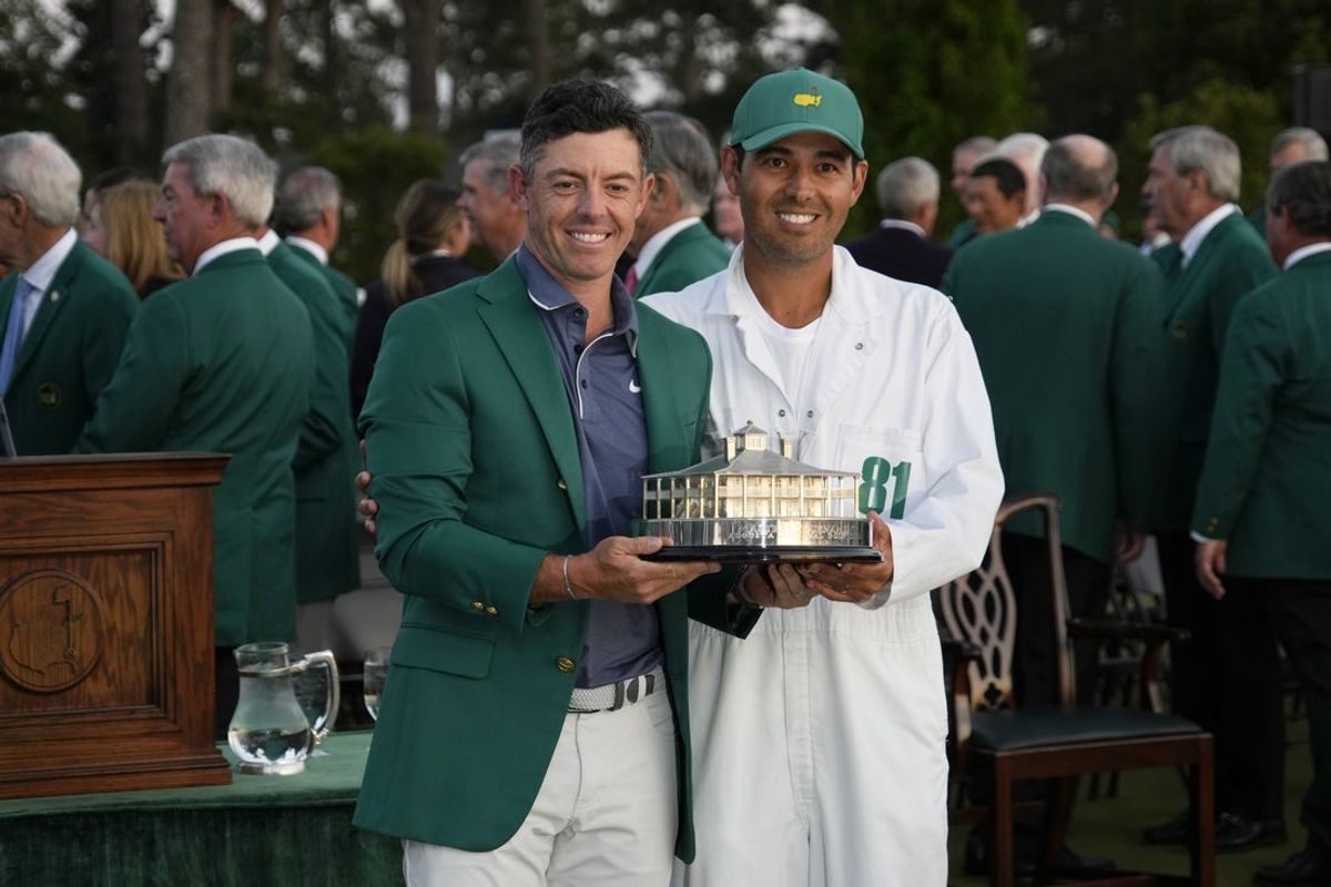 Apr 13, 2025; Augusta, Georgia, USA; Rory McIlroy and his caddie Harry Diamond celebrate with the trophy after winning the Masters Tournament at Augusta National Golf Club. Mandatory Credit: Michael Madrid-Imagn Images