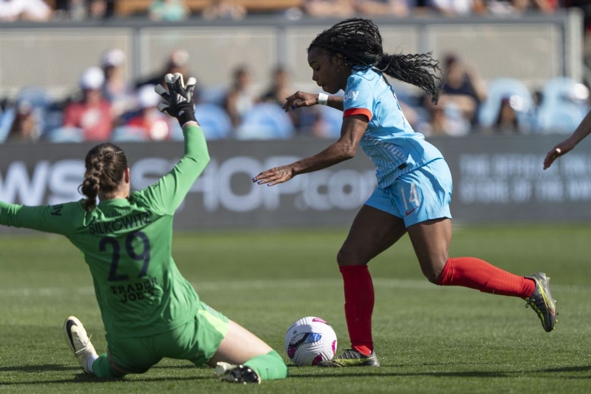 Apr 13, 2025; San Jose, California, USA;  Bay FC goalkeeper Jordan Silkowitz (29) defends against Chicago Stars FC forward Ludmila (14) during the first half at PayPal Park. Mandatory Credit: Stan Szeto-Imagn Images