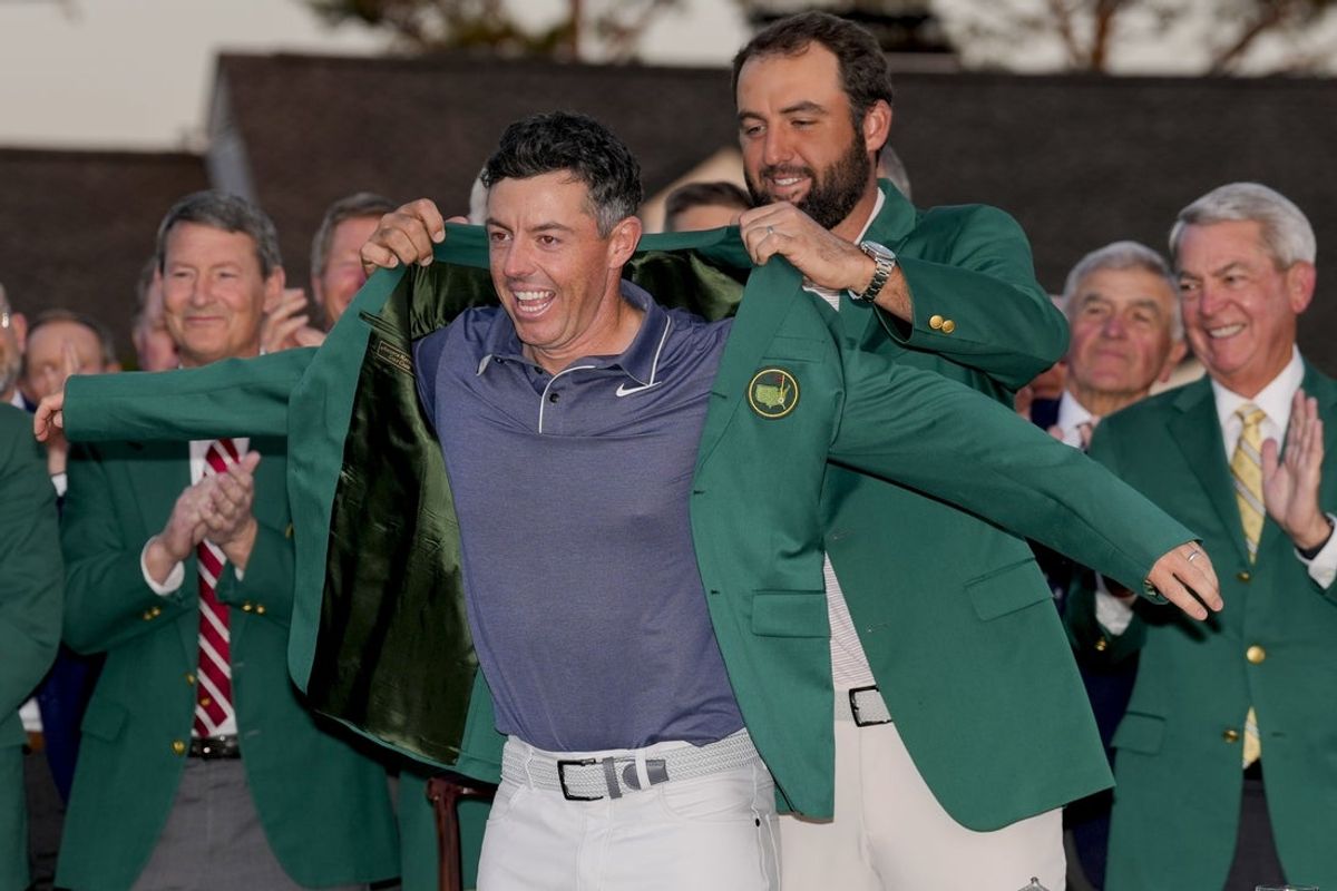 Apr 13, 2025; Augusta, Georgia, USA; Scottie Scheffler places the green jacket on Rory McIlroy during the green jacket ceremony during the final round of the Masters Tournament at Augusta National Golf Club. Mandatory Credit: Kyle Terada-Imagn Images