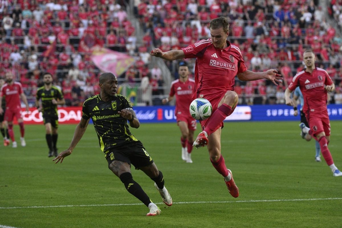 Apr 13, 2025; St. Louis, Missouri, USA; St. Louis City defender Henry Kessler (5) controls the ball from Columbus Crew midfielder Darlington Nagbe (6) during the first half at CITYPARK. Mandatory Credit: Jeff Le-Imagn Images