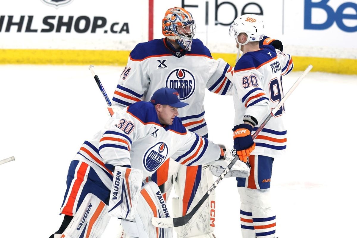 Apr 13, 2025; Winnipeg, Manitoba, CAN; Edmonton Oilers goaltender Stuart Skinner (74), Edmonton Oilers goaltender Calvin Pickard (30) and Edmonton Oilers right wing Corey Perry (90) celebrate their victory over the Winnipeg Jets at Canada Life Centre. Mandatory Credit: James Carey Lauder-Imagn Images