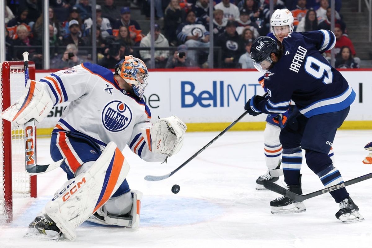Apr 13, 2025; Winnipeg, Manitoba, CAN; Winnipeg Jets left wing Alex Iafallo (9) scores on Edmonton Oilers goaltender Stuart Skinner (74) in the second period at Canada Life Centre. Mandatory Credit: James Carey Lauder-Imagn Images